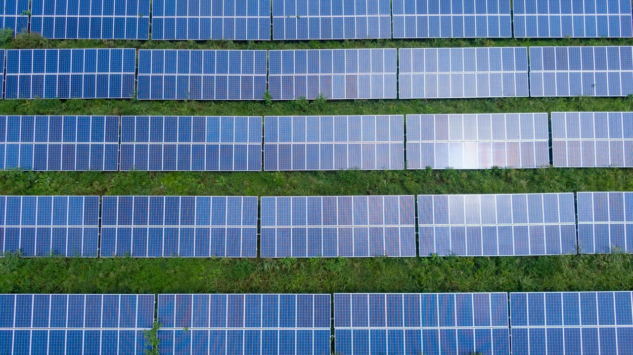 Rows of solar panels under development across a field